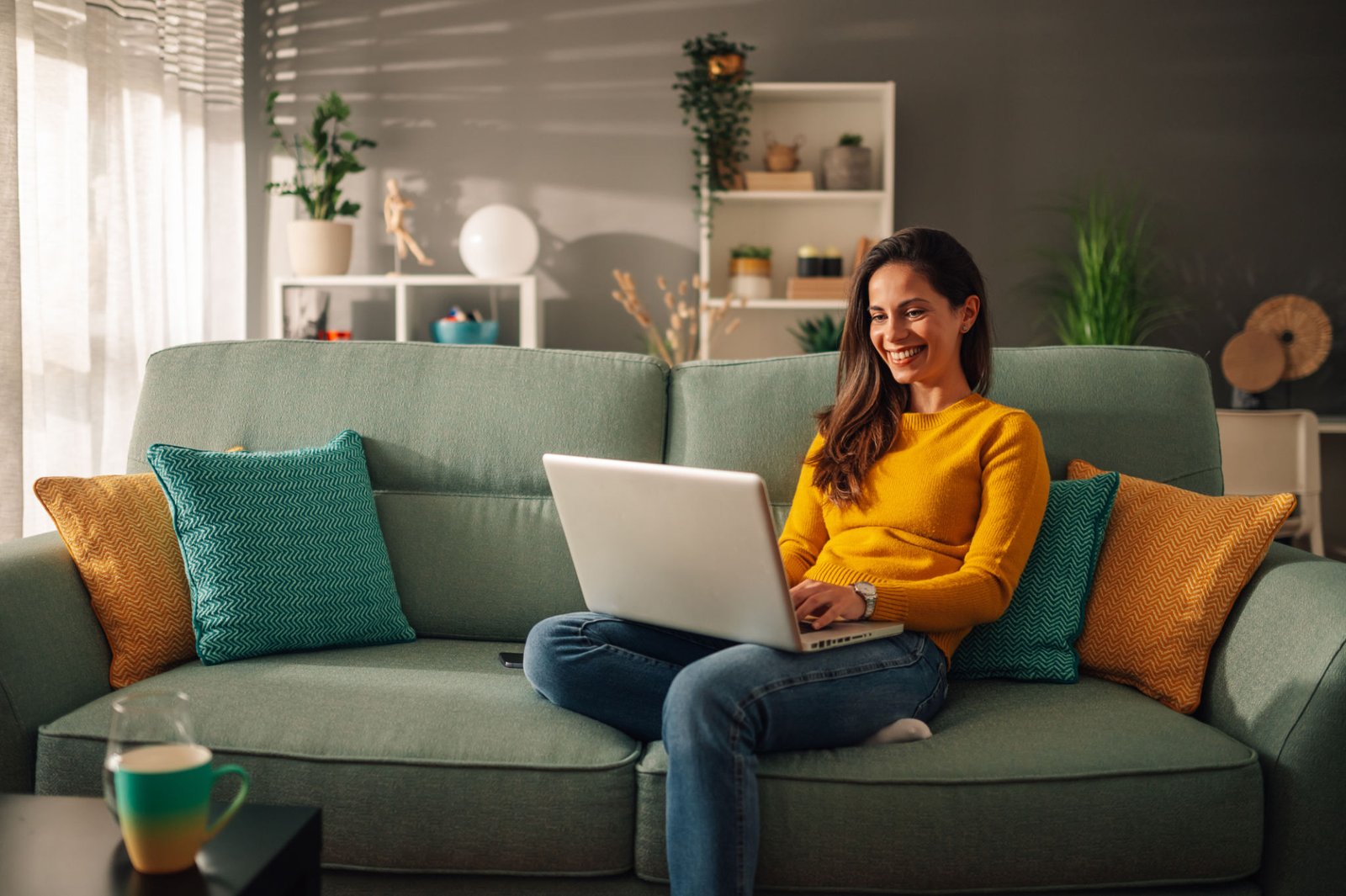 Independent contractor working on a laptop at home, representing 1099 Mortgage Loan options at The Wright Loans